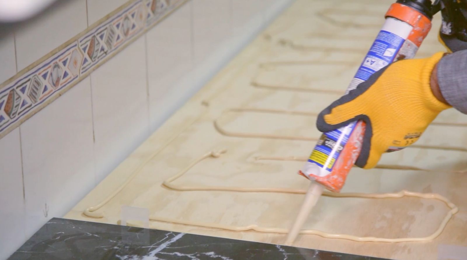 Aplicación del adhesivo de montaje para pegar porcelanato