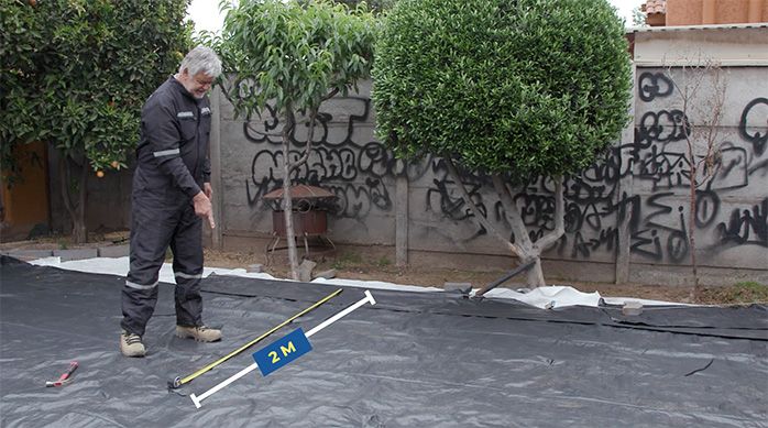 Una persona determina el centro del jardín de piedras