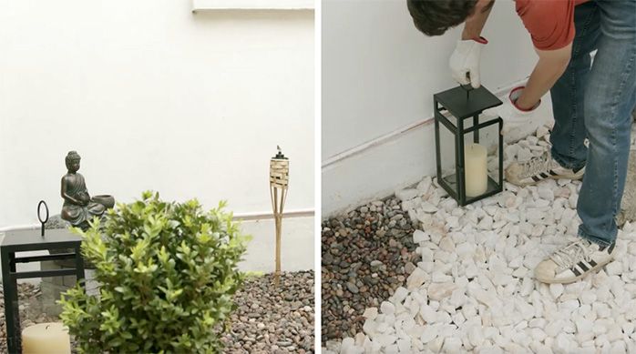 Una persona pone un farol con velas, fuente de agua y antorchas en el jardín japonés en casa