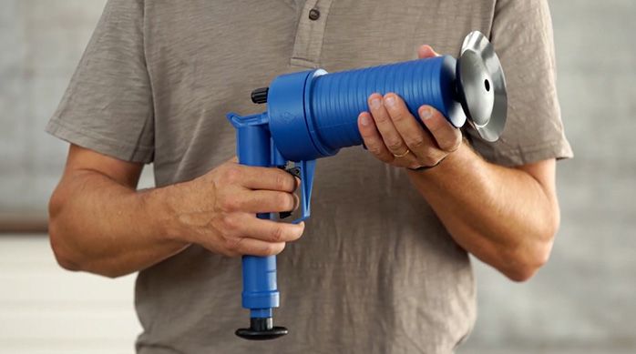 una persona sostiene un destapador de presión con bomba incluida modelo drain blaster