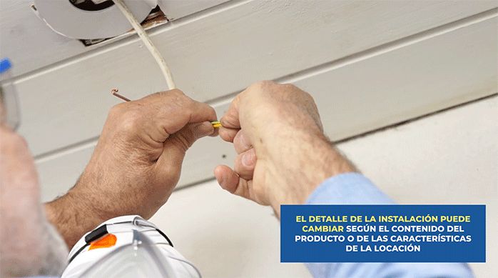 un hombre conecta una cámara de seguridad inteligente a la conexión eléctrica en la entrada de una casa.