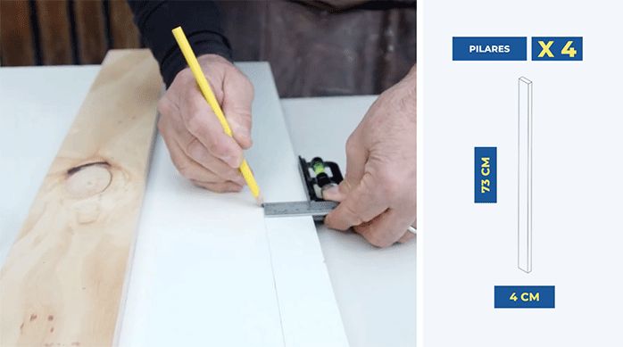 un hombre marca un trozo de melamina para construir un mueble de cocina para ocultar el cilindro de gas.
