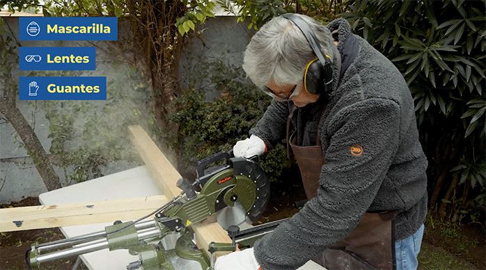 un hombre corta un trozo de madera usando una sierra ingleteadora.