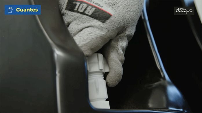 una persona atornilla los flexibles del sanitario.