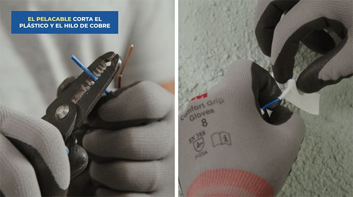 una persona con guantes de seguridad pela los cables de una conexión eléctrica.
