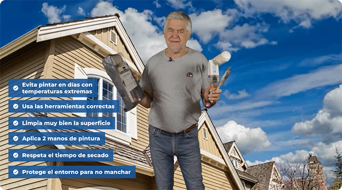 un hombre adulto mayor con polera gris sostiene varios implementos para pintar: rodillos, brochas, bandejas y más.