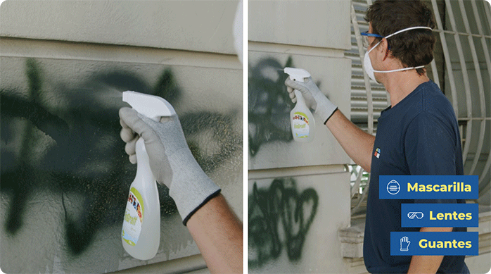 un hombre con anteojos de seguridad, mascarilla y guantes aplica removedor para grafiti en el muro de una fachada.