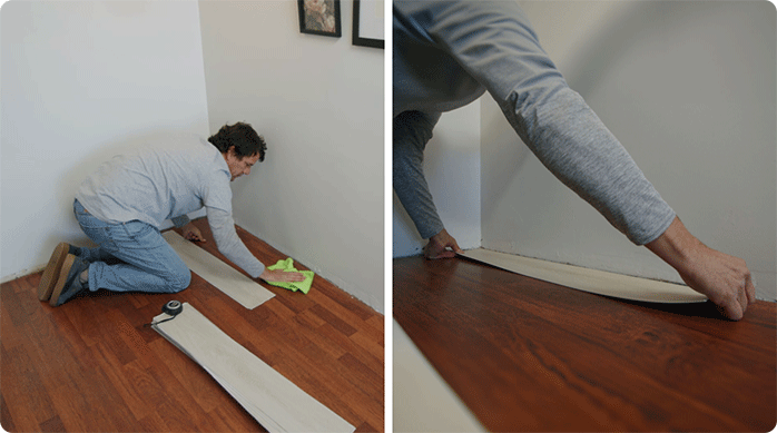 un hombre limpia el piso flotante y luego pega una plancha de piso vinílico adhesivo encima.