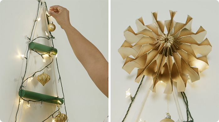 una persona pone luces led, adornos y la estrella de cartón en el árbol de Navidad colgante.