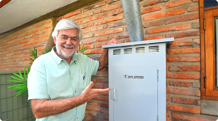 un hombre mayor sonriendo muestra cómo quedó el gabinete para calefont exterior que acaba de instalar.