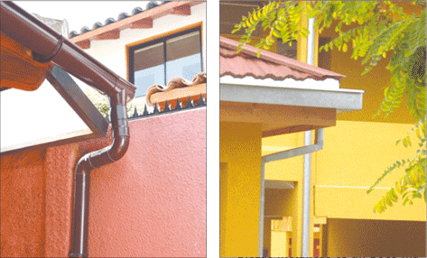 canaleta de agua color café instalada en el techo de una casa